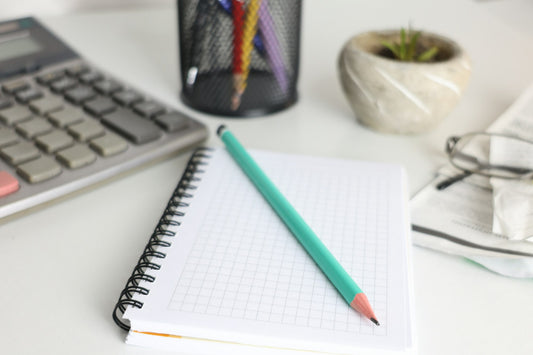 Calcolatrice e quaderno per organizzare le spese mensili